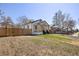 Home featuring a covered front porch, landscaping and fenced yard at 4780 Pennsylvania St, Denver, CO 80216