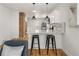 Kitchen with white cabinets, granite countertops, stainless steel appliances and a bar area with pendant lighting at 4780 Pennsylvania St, Denver, CO 80216