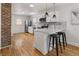 Well-lit kitchen featuring stainless steel appliances, granite countertops, and white cabinetry with wood floors at 4780 Pennsylvania St, Denver, CO 80216