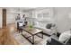 Bright living room with hardwood floors, neutral tones, and an open layout to the kitchen at 4780 Pennsylvania St, Denver, CO 80216