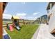 Enjoy a lush backyard with artificial grass, a playground, and patio space for outdoor activities at 4918 Preserve Pl, Firestone, CO 80504