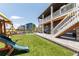 Spacious backyard features artificial turf, a play set, covered patio, and outdoor seating at 4918 Preserve Pl, Firestone, CO 80504