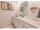 Modern bathroom with white vanity, a large mirror, and minimalist decor at 4918 Preserve Pl, Firestone, CO 80504