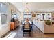 Open concept living and dining room with floor-to-ceiling windows and modern decor at 4918 Preserve Pl, Firestone, CO 80504