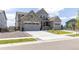 Beautiful two-story home with a three car garage and stone and siding exterior at 4918 Preserve Pl, Firestone, CO 80504