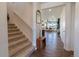Bright foyer with staircase and hardwood floors, offering a glimpse into the living spaces at 4918 Preserve Pl, Firestone, CO 80504