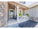 Inviting front porch with decorative railings and potted plants offering a warm welcome at 4918 Preserve Pl, Firestone, CO 80504