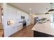 Well-appointed kitchen with stainless steel appliances, white cabinets, and stylish countertops at 4918 Preserve Pl, Firestone, CO 80504