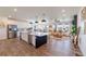Bright open kitchen and living area with a large island and plenty of natural light at 4918 Preserve Pl, Firestone, CO 80504