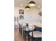Kitchen island with barstool seating, pendant lights, and decor at 4918 Preserve Pl, Firestone, CO 80504