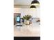 Close-up of the kitchen island with black accents, white countertop, decor, and pendant lights at 4918 Preserve Pl, Firestone, CO 80504