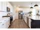 Bright kitchen featuring white cabinets, stainless steel appliances, and center island with bar seating at 4918 Preserve Pl, Firestone, CO 80504