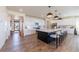 Spacious kitchen featuring a large island with seating, white cabinets, and modern appliances at 4918 Preserve Pl, Firestone, CO 80504