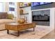 Modern living room features a stylish fireplace and a wooden coffee table with drawers at 4918 Preserve Pl, Firestone, CO 80504