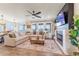 Spacious open-concept living room with modern decor, fireplace and lots of natural light at 4918 Preserve Pl, Firestone, CO 80504