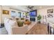 Bright living room features a cozy sofa, fireplace, and large windows offering great light at 4918 Preserve Pl, Firestone, CO 80504
