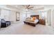 Spacious main bedroom with a tray ceiling, neutral carpet and large windows allowing for natural light at 4918 Preserve Pl, Firestone, CO 80504