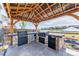 Entertain outdoors with a full kitchen, grill, and bar area in the backyard at 4918 Preserve Pl, Firestone, CO 80504