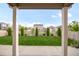A view of the backyard of the house with a grass lawn and decorative trees at 6922 Vermillion St, Frederick, CO 80530