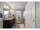 Bright bathroom has double sinks and vanity, plus shower/tub combo with curtain at 6922 Vermillion St, Frederick, CO 80530