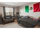 A carpeted bedroom has a couch, desk, and large Mexican flag on the wall at 6922 Vermillion St, Frederick, CO 80530