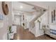 Inviting foyer with hardwood floors, staircase, and stylish decor at 6922 Vermillion St, Frederick, CO 80530