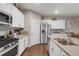 Bright kitchen with stainless steel appliances, ample counter space, and modern design at 6922 Vermillion St, Frederick, CO 80530