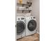 This laundry room with modern washer and dryer appliances, features useful shelving for storage at 6922 Vermillion St, Frederick, CO 80530