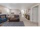 Bright living room with cozy seating, stylish decor, and neutral walls over plush carpeting at 6922 Vermillion St, Frederick, CO 80530