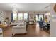 Bright living room with hardwood floors, comfortable seating, and abundant natural light at 6922 Vermillion St, Frederick, CO 80530