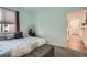 Light and airy bedroom with a comfortable bed and access to a hallway at 8465 S Holland Way # 205, Littleton, CO 80128
