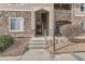 Condo building entrance with stairs and stonework at 8465 S Holland Way # 205, Littleton, CO 80128