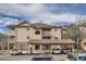 Tan two-story condo building with balconies and carport at 8465 S Holland Way # 205, Littleton, CO 80128