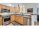 Modern kitchen featuring stainless steel appliances and ample wood cabinetry at 8465 S Holland Way # 205, Littleton, CO 80128