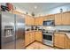 Stainless steel appliances and light wood cabinets highlight this kitchen at 8465 S Holland Way # 205, Littleton, CO 80128