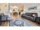 Open concept living room with hardwood floors and gray couch at 8465 S Holland Way # 205, Littleton, CO 80128