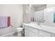 Bright bathroom features white cabinets, white countertop, gold faucet and mirror at 9287 Twenty Mile Rd # 204, Parker, CO 80134
