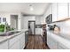 Modern kitchen with stainless steel appliances, granite countertops, and sleek white cabinetry at 9287 Twenty Mile Rd # 204, Parker, CO 80134