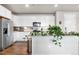Bright, stylish kitchen featuring white cabinets, granite countertops, and stainless steel appliances at 9287 Twenty Mile Rd # 204, Parker, CO 80134