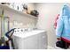 Bright laundry room features a full-size, front-loading washer and dryer, with storage shelf above at 9287 Twenty Mile Rd # 204, Parker, CO 80134