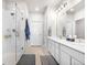Large bathroom has double sinks, white cabinets, and walk-in shower at 9287 Twenty Mile Rd # 204, Parker, CO 80134