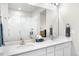 Bright bathroom with double sinks, walk-in shower with glass door and white tiling at 9287 Twenty Mile Rd # 204, Parker, CO 80134