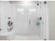 The bright bathroom features a spacious glass shower and white tiling at 9287 Twenty Mile Rd # 204, Parker, CO 80134