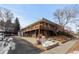 Multi-unit building with a large deck and parking in front at 3211 Newton St, Denver, CO 80211