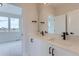 Modern bathroom with double sinks, black fixtures, and a large mirror reflecting natural light at 5575 Moosehead Cir, Longmont, CO 80503