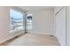 Bright bedroom featuring light hardwood floors, large windows offering lots of natural light, and a closet at 5575 Moosehead Cir, Longmont, CO 80503