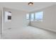 Well-lit bedroom featuring neutral carpet and multiple windows at 5575 Moosehead Cir, Longmont, CO 80503