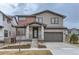 Charming two-story home with a modern gray exterior and stone accents and well-maintained landscaping at 5575 Moosehead Cir, Longmont, CO 80503