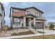 Charming two-story home with a modern gray exterior and stone accents, concrete stairs and minimal yard at 5575 Moosehead Cir, Longmont, CO 80503