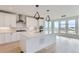 Bright kitchen with white cabinets, stainless steel appliances, and a large center island at 5575 Moosehead Cir, Longmont, CO 80503